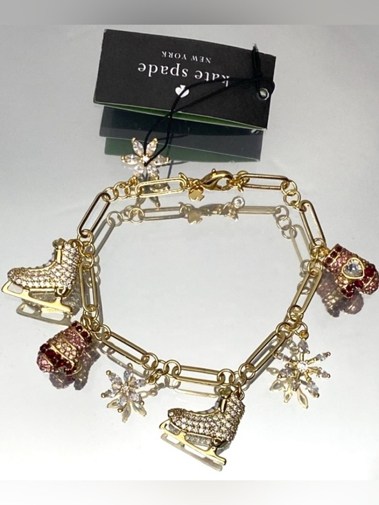kate spade Jewelry - kate spade Gold-Tone Ice Skate & Snowflake Charm Bracelet with Pink Accents